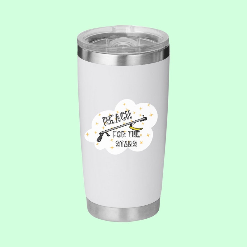 Puede incluir: Un vaso de acero inoxidable blanco con una pegatina que dice "Reach for the stars" y presenta una imagen de dibujos animados de un pl&aacute;tano que es agarrado por una herramienta con una estrella en el extremo.