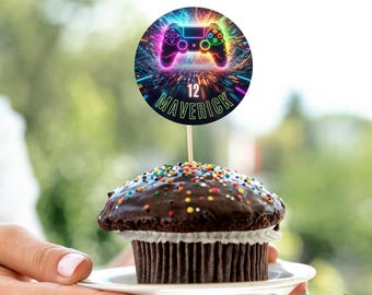 May include: A chocolate cupcake with colorful sprinkles, topped with a gaming-themed decoration. The decoration features a neon-colored game controller design with the text "12 Maverick" and the words "Instant Download Editable Template".