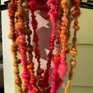 Art yarn 5 yds super jumbo yarn in transitional shades of reds rusts golds and pinks Llama