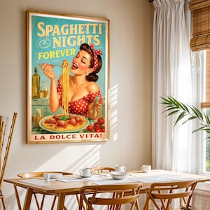 May include: A framed vintage-style poster with the text "Spaghetti Nights Forever" and "La Dolce Vita!" features a woman in a red polka-dot dress enjoying spaghetti. The poster is in a gold frame and hangs above a wooden dining table.