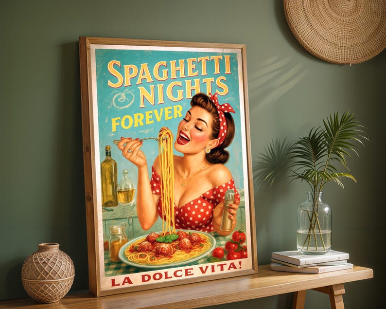 May include: A framed vintage-style poster with the words "Spaghetti Nights Forever" and "La Dolce Vita!" A woman in a red polka-dot dress is eating spaghetti. The poster has a wooden frame and is displayed on a wooden table.
