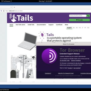 May include: A screenshot of a computer screen showing the Tails website. The website is purple and white and features a cartoon laptop with a city skyline in the background. The text "Tails is a portable operating system that protects against" is displayed on the website. A pop-up window is open on the screen, showing the Tor Browser logo and the text "Tor Browser Extended Support Release".