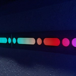 May include: A row of colorful lights in a dark room. The lights are arranged in a line and are of different colors, including blue, green, yellow, orange, red, and purple.