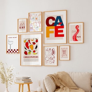 May include: A collection of eight framed prints with various designs. The prints feature colorful illustrations of cocktails, food, and text. The prints are arranged in a grid pattern on a white wall.