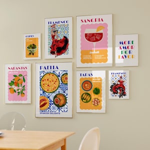 May include: A set of eight colorful prints with Spanish-themed illustrations and text. The prints feature images of oranges, olives, sangria, paella, tapas, and flamenco dancers. The text includes the words "Naranjas", "Paella", "Tapas", "Flamenco", "Sangria", "Olives", "More Amor Por Favor", and "Spanish Delights".