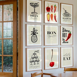 May include: A set of nine framed prints with a kitchen theme. The prints feature illustrations of cocktails, food, and text. The prints are in black and white with red accents. The prints are hung on a white wall.