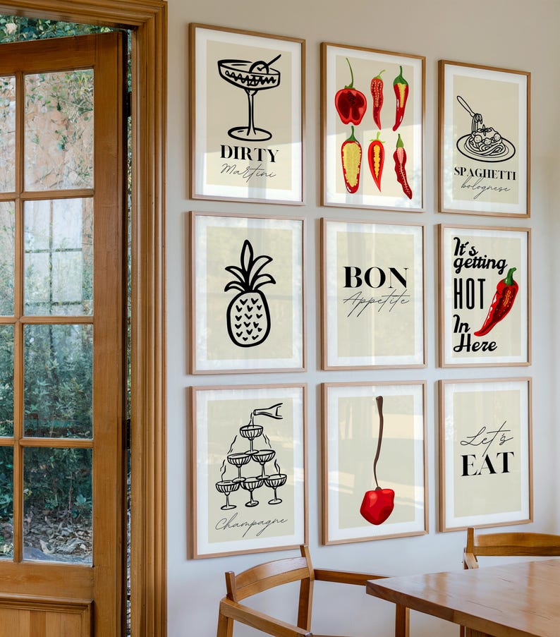 May include: A set of nine framed prints with a kitchen theme. The prints feature illustrations of cocktails, food, and text. The prints are in black and white with red accents. The prints are hung on a white wall.