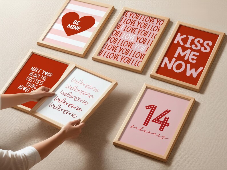 May include: A set of eight framed prints with Valentine's Day themes. The prints feature red and pink hearts, stripes, and text that says "Be Mine", "Kiss Me Now", "Valentine", "Make Your Heart The Prettiest Thing About You", and "14 February".