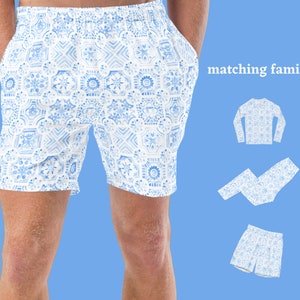May include: Matching family pajamas with a blue and white geometric pattern. The image shows a pair of shorts, a long-sleeved shirt, a pair of pants, and a pair of shorts.