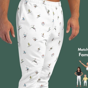May include: White sweatpants with a repeating pattern of skiers on a white background. The text "Matching Family" is visible in the bottom right corner of the image.