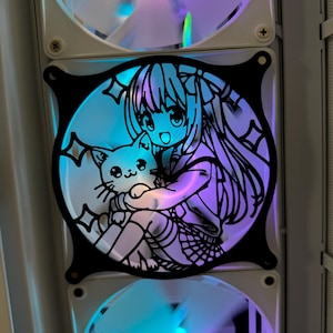 May include: A black metal fan grill with a cut-out design of an anime girl holding a cat. The girl has long hair and is wearing a dress. The background is a blue and purple gradient.