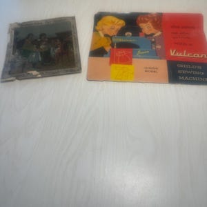 Victorian Muller toy sewing machine box art and Vulcan box