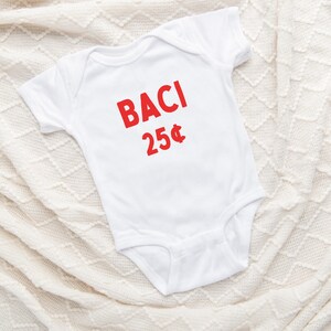 May include: White baby onesie with red text that says "BACI 25&cent;".
