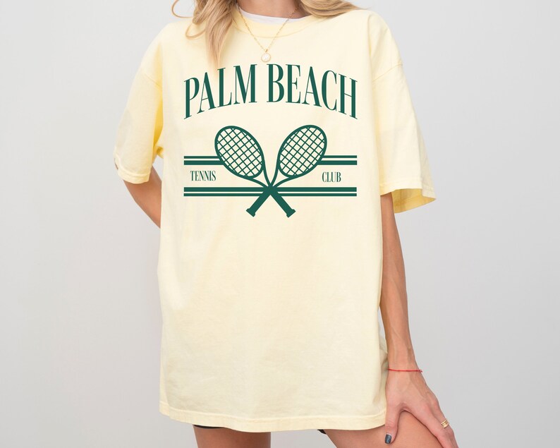 May include: A yellow t-shirt with a graphic print of two crossed tennis rackets and the text "PALM BEACH TENNIS CLUB".