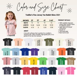 May include: A colour and size chart for the Rabbit Skins 3321 toddler fine jersey tee. The chart displays measurements in inches for sizes 2T through 5-6T, product details, and a grid of thirty-two t-shirt colour options with labels.