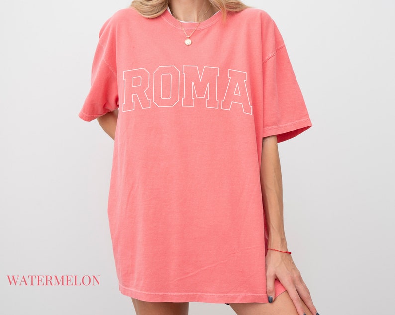May include: A watermelon-colored oversized t-shirt with the word "ROMA" printed in white on the front.