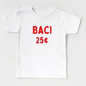 May include: White t-shirt with red text that says "BACI 25&cent;".