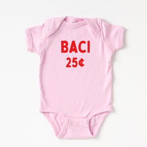 May include: A pink baby onesie with the words "BACI 25&cent;" printed in red.