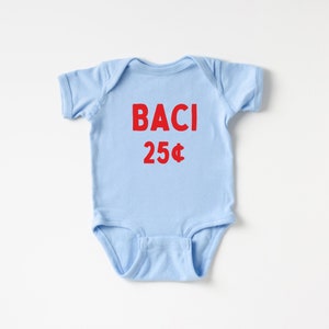 May include: A light blue baby onesie with the text "BACI 25&cent;" printed in red.