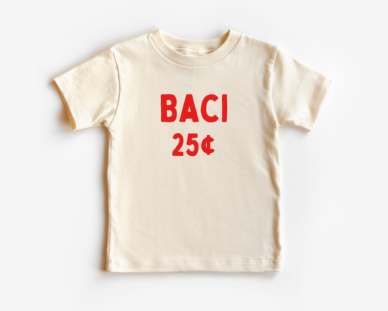May include: A cream colored t-shirt with red text that says "BACI 25&cent;".