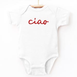 May include: White baby onesie with red embroidered text that says "ciao".