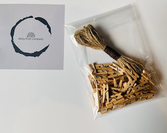 May include: A clear plastic bag filled with a large quantity of small wooden clothespins. A ball of twine is also included in the bag.