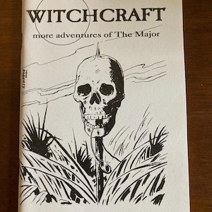 May include: Black and white illustration of a skull on a stick, surrounded by grass. The text "WITCHCRAFT" and "more adventures of The Major" is printed above the illustration. The text "L. Patrick Greene" is printed below the illustration.