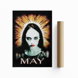 May include: A movie poster for the horror film "May" featuring a woman with pale skin and red lips. She is surrounded by a halo of scissors.