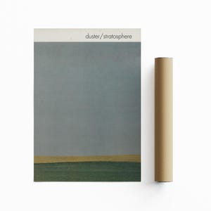 May include: A poster with a light blue sky and a thin yellow line at the bottom. The text "duster/stratosphere" is printed at the top of the poster.