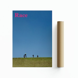 May include: A poster featuring the word "Race" in pink lettering against a blue sky. Three figures are walking on a grassy hill in the distance.