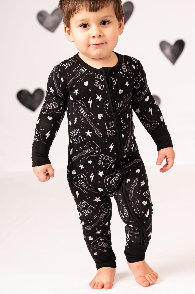 Valentines Day Love Rocks Bamboo Zip Up Baby and Toddler Pajamas. Black and white design with Guitars, Lightning bolts and stars. Sizes Newborn to 2T. Perfect New Baby Gift. Unisex design makes it great for Boys and Girls.