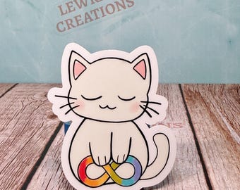 May include: A white cat sticker with pink inner ears and closed eyes, holding a rainbow infinity symbol. The sticker has black whiskers and a black outline. The text "LEWRAD CREATIONS" is visible in the background.