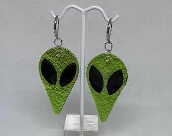 Alienny green real leather metallic drop earrings - My own design, with resin black eyes and brown leather backing.