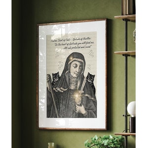 May include: A black and white illustration of a woman in a nun's habit holding a cross. Two black cats are flanking her. The text reads "Patron Saint of Cats - Gertrude of Nevilles. In the heart of Gertrude you will find me... All cats protected and Loved."