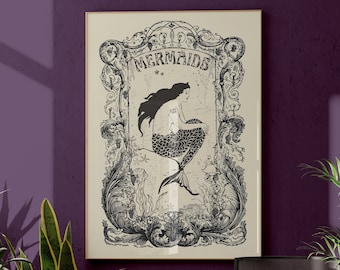 May include: A framed black and white illustration of a mermaid with the word "Mermaids" above it, hanging on a purple wall. The artwork is surrounded by ornate details. The room features a beige sofa, plants, and a modern chair.