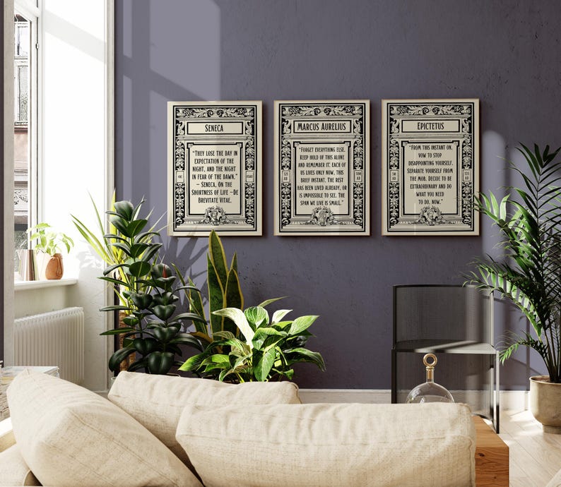 May include: Three framed prints with black and white text on a white background. The prints feature quotes from Seneca, Marcus Aurelius, and Epictetus. The frames are ornate and have a black and white design.