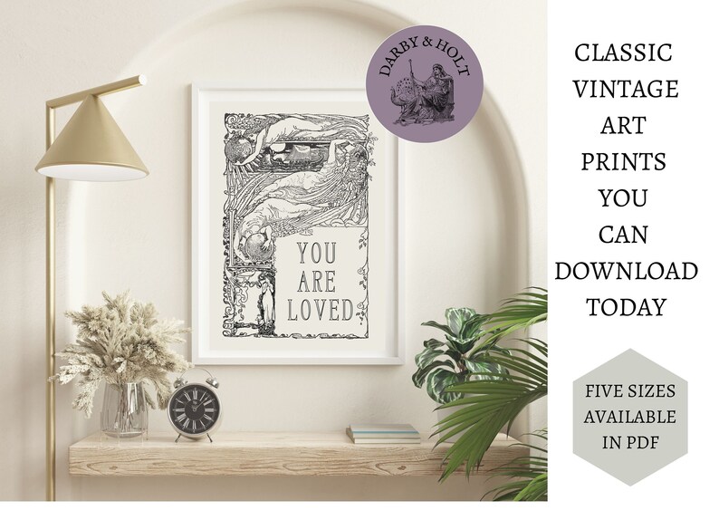 May include: A black and white vintage art print with a decorative border and the text "You Are Loved". The print is framed in a white frame and is hanging on a white wall.