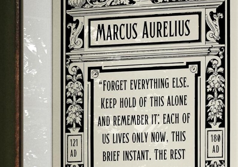 May include: Black and white framed print with a quote by Marcus Aurelius. The quote reads "Forget everything else. Keep hold of this alone and remember it: Each of us lives only now, this brief instant. The rest..." The print also includes the years 121 AD and 180 AD.