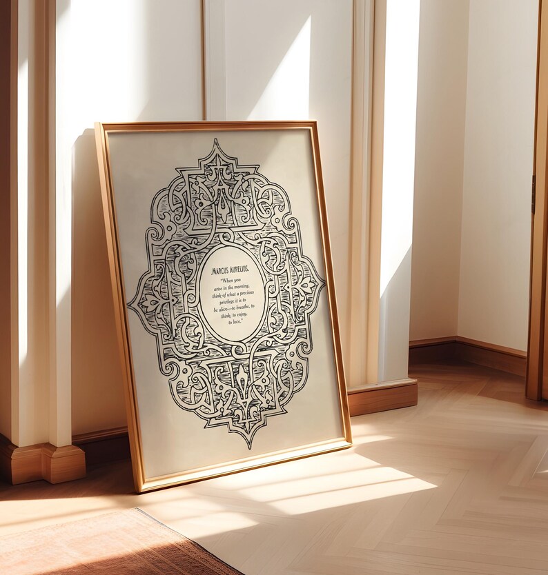 May include: A black and white print of an intricate design with a quote by Marcus Aurelius. The quote reads, "When you arise in the morning think of what a precious privilege it is to be alive - to breathe, to think, to enjoy, to love."
