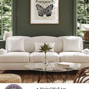 Peut inclure: Une impression d'art mural num&eacute;rique repr&eacute;sentant une illustration en noir et blanc d'un papillon avec le texte "Fly be free". L'impression est encadr&eacute;e et affich&eacute;e sur un mur dans un salon.