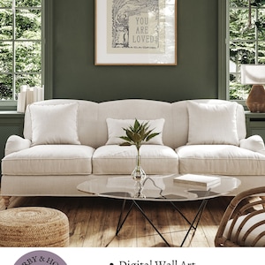 May include: A digital wall art print with the text "You are loved" in a vintage style. The print is framed and hanging on a green wall above a white sofa. The print is available in five sizes.