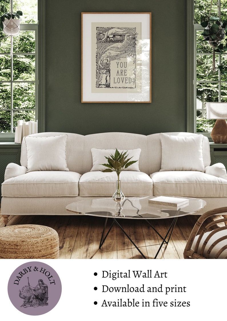 May include: A digital wall art print with the text "You are loved" in a vintage style. The print is framed and hanging on a green wall above a white sofa. The print is available in five sizes.