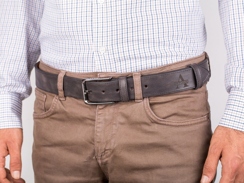 May include: A brown leather belt with a silver buckle and the name "Antonio" engraved on the strap.