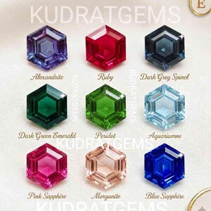 May include: A collection of nine hexagonal cut gemstones arranged in a grid. The stones include purple Alexandrite, red Ruby, dark grey Spinel, dark green Emerald, green Peridot, light blue Aquamarine, pink Sapphire, peach Morganite, and blue Sapphire.
