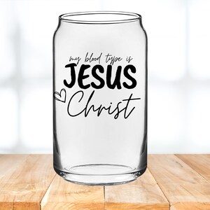 May include: A clear glass can with the text "my blood type is JESUS Christ" printed on it. The text is in black and the word "JESUS" is in a larger font than the rest of the text.