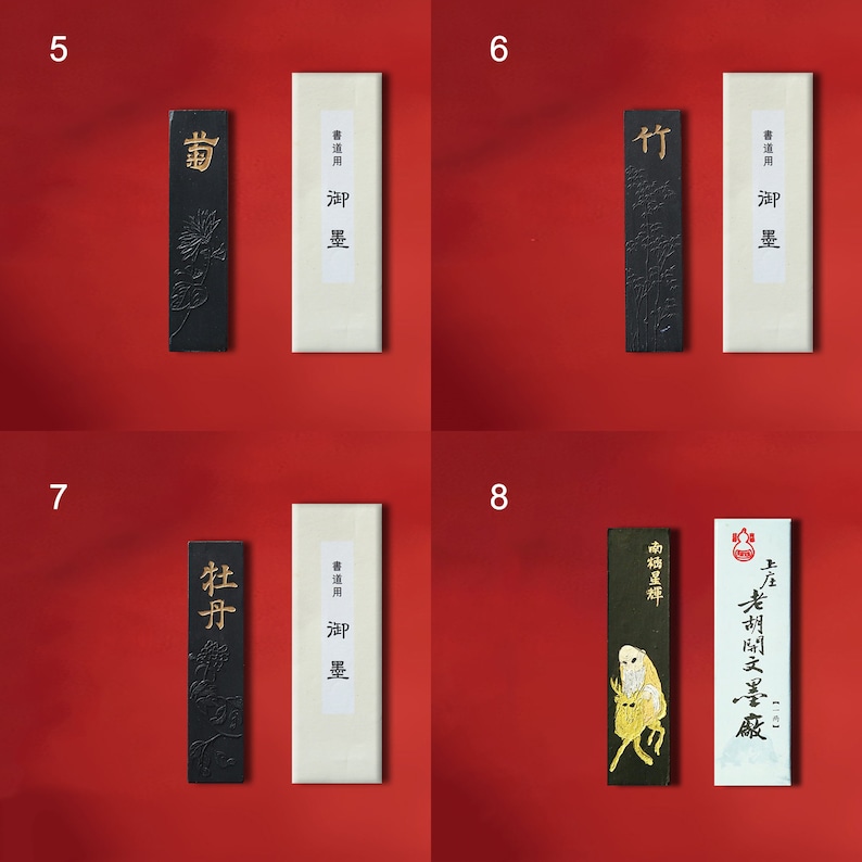 May include: Four black ink sticks with gold lettering and decorative designs. Each stick is accompanied by a white label with black text that reads "書道用油墨" which translates to "Calligraphy Ink".