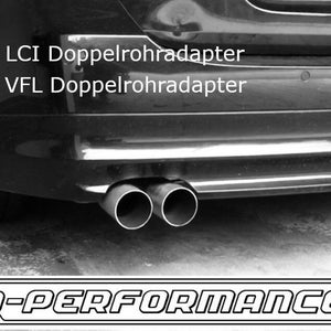May include: Black and white photo of a car's rear bumper with two exhaust pipes. The text "e9X LCI Doppelrohr adapter" and "e9X VFL Doppelrohr adapter" is visible on the bumper. The text "Q-PERFORMANCE" is visible at the bottom of the image.