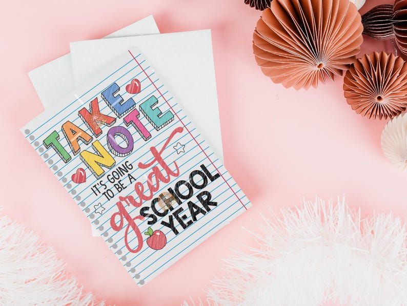 May include: A white notebook with a colourful "Take Note" title and the text "It's going to be a great school year". The notebook has a red apple graphic and a rainbow of colours in the title.