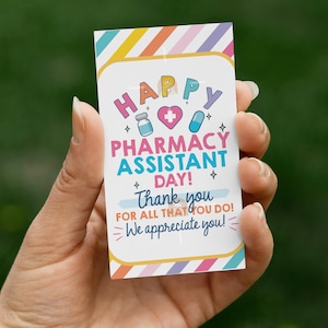 May include: A colourful card with the text "HAPPY PHARMACY ASSISTANT DAY!" and "Thank you for all that you do!" in a playful font. The card features pharmacy-related icons and a striped border.