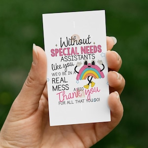 May include: A white card with the text "Without SPECIAL NEEDS ASSISTANTS like you WE'D BE IN A REAL MESS Thank you FOR ALL THAT YOU DO!" A cartoon rainbow is also on the card.